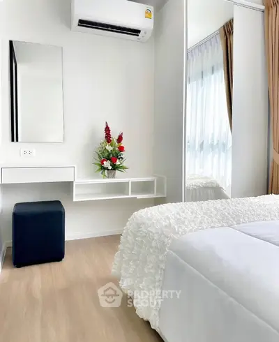 Modern bedroom with elegant decor, featuring a cozy bed, stylish mirror, and air conditioning for ultimate comfort.