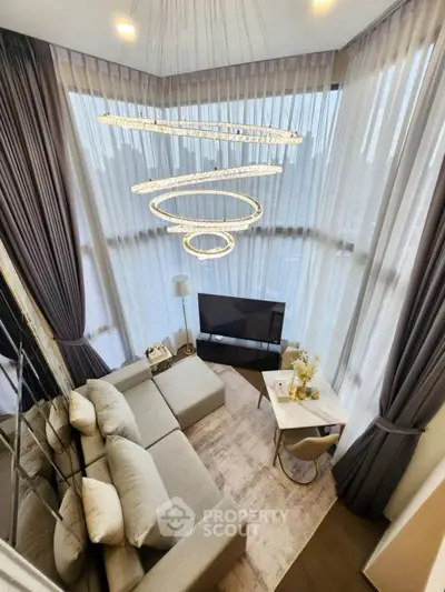 Luxurious modern living room with floor-to-ceiling windows and elegant chandelier