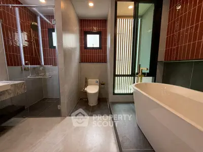 Luxurious modern bathroom with freestanding tub and glass shower enclosure