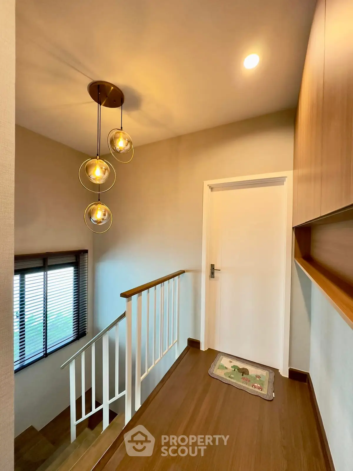 Stylish staircase landing with modern lighting and wooden accents