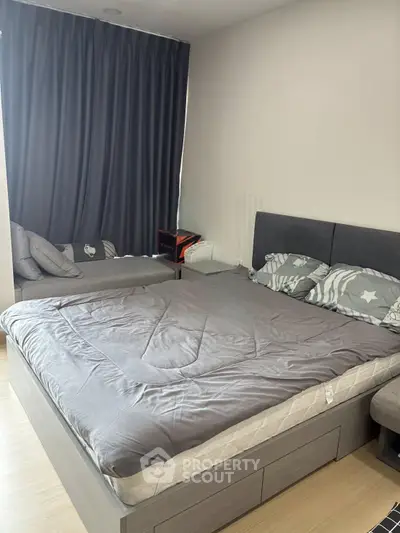 Cozy bedroom with modern gray decor and ample natural light