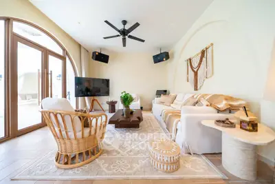 Luxurious living room with elegant decor, large windows, and cozy seating area.