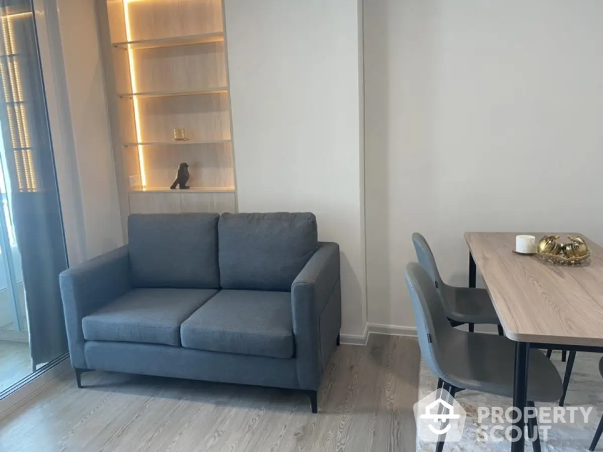 Modern living room with sleek grey sofa and stylish dining area