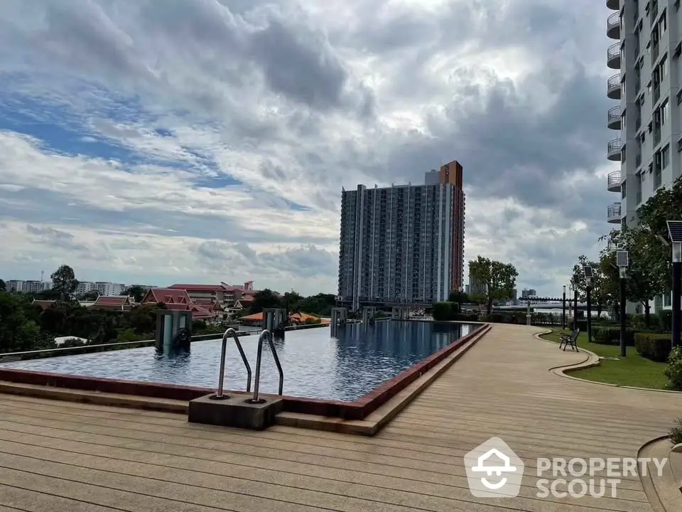 Stunning rooftop infinity pool with panoramic city views in modern high-rise building.