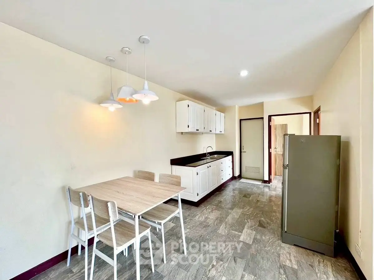 Spacious kitchen with modern dining area and ample storage