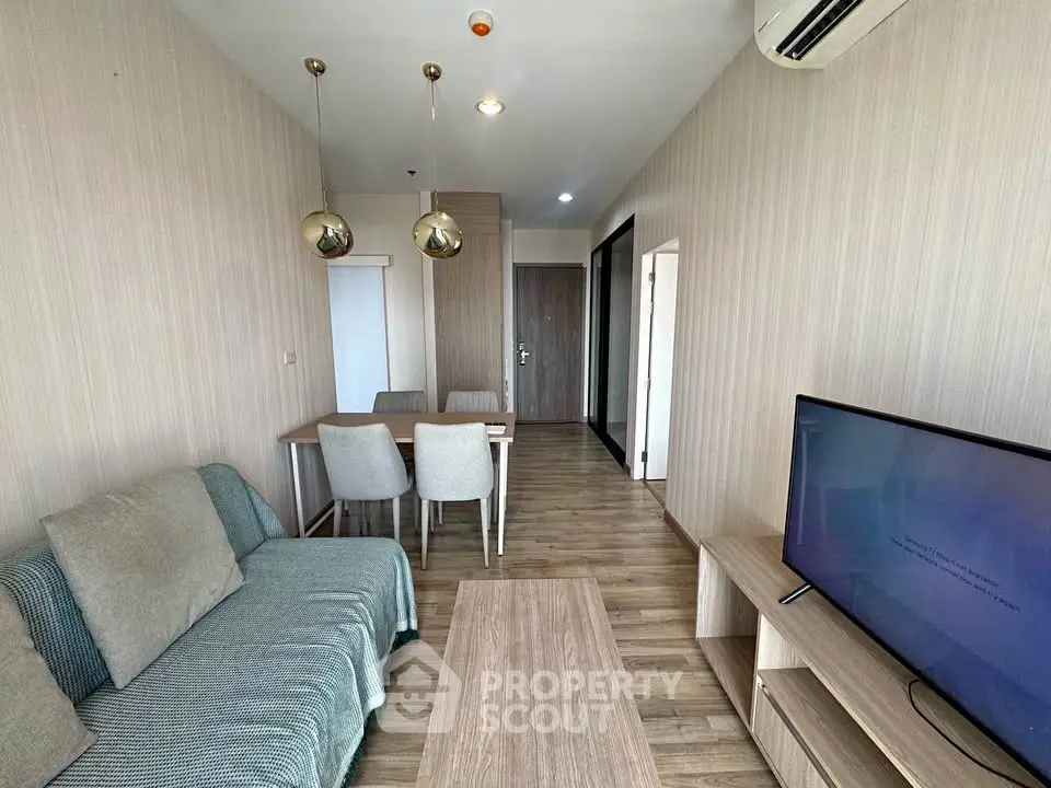 Modern living room with stylish decor and wooden flooring in a cozy apartment.