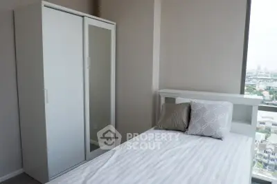 Modern bedroom with sleek wardrobe and city view, perfect for urban living.