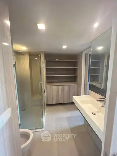 Modern bathroom with sleek fixtures and glass shower enclosure