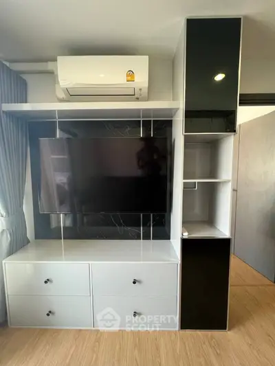 Modern living room with sleek TV unit and air conditioning, perfect for comfortable living.