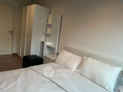 Cozy bedroom with modern furniture and soft lighting, perfect for relaxation.