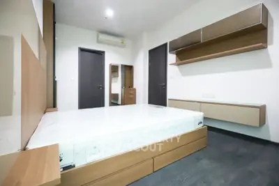 Modern minimalist bedroom with sleek furniture and ample storage space