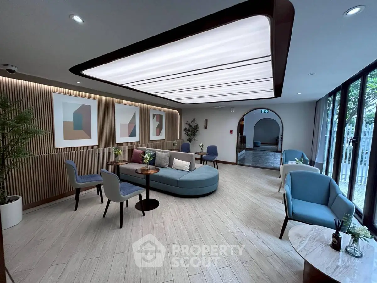 Elegant modern living room with stylish furniture and large windows offering natural light.