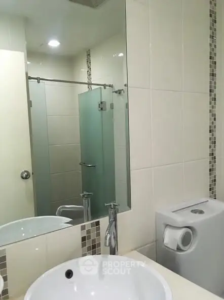 Modern bathroom with sleek fixtures and glass shower door