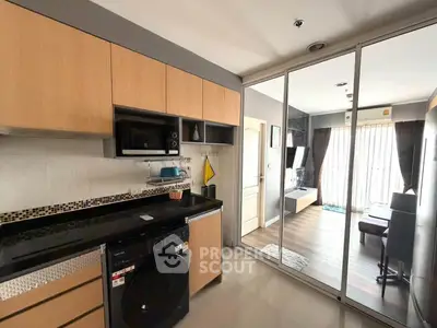 Modern kitchen with washing machine and open layout to living room