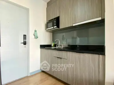 Modern kitchen with sleek cabinetry and built-in appliances in a stylish apartment.