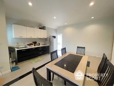 Modern kitchen with dining area and sleek cabinetry