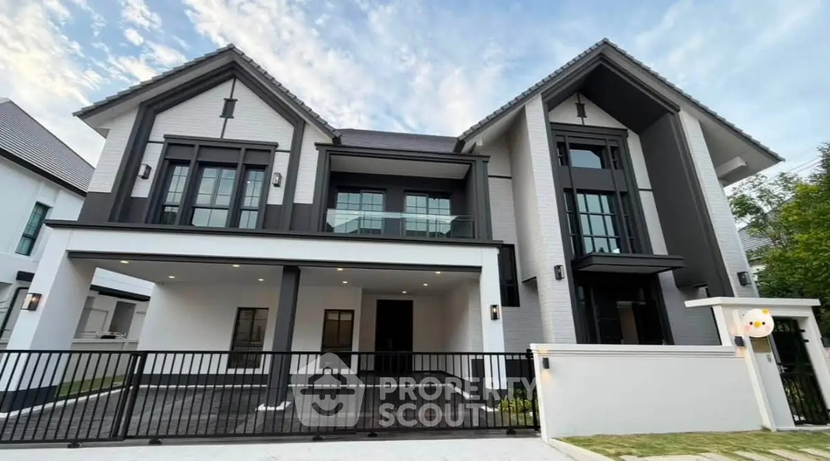 Stunning modern two-story house with sleek design and spacious driveway, perfect for luxurious living.