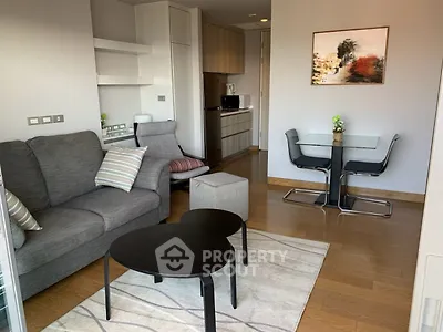 Modern living room with stylish furniture and open kitchen layout, perfect for urban living.