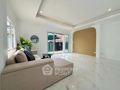 Spacious modern living room with elegant marble flooring and large windows for natural light.