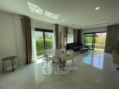 Spacious modern living room with large windows and garden view