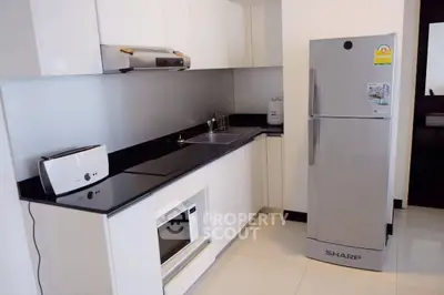 Modern kitchen with sleek appliances and glossy white cabinets