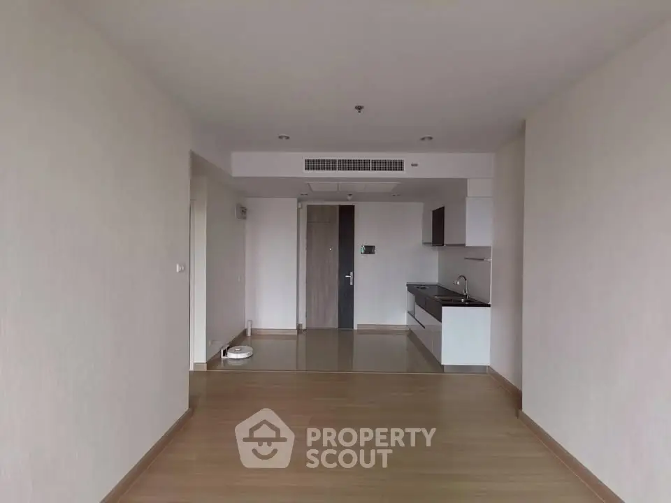 Spacious modern apartment with open layout and sleek kitchen design.