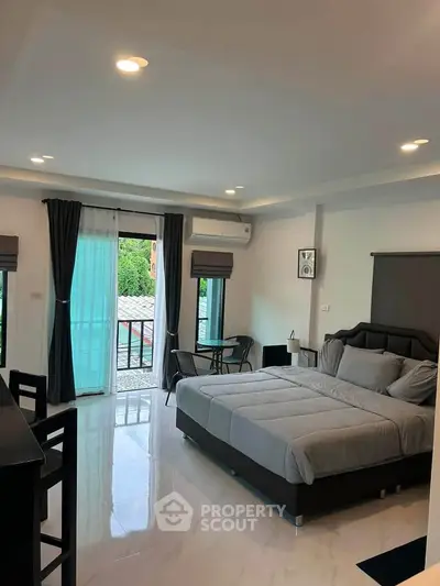 Spacious modern bedroom with large windows and elegant decor