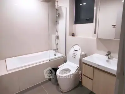Modern bathroom with sleek fixtures and a bathtub in a contemporary apartment.