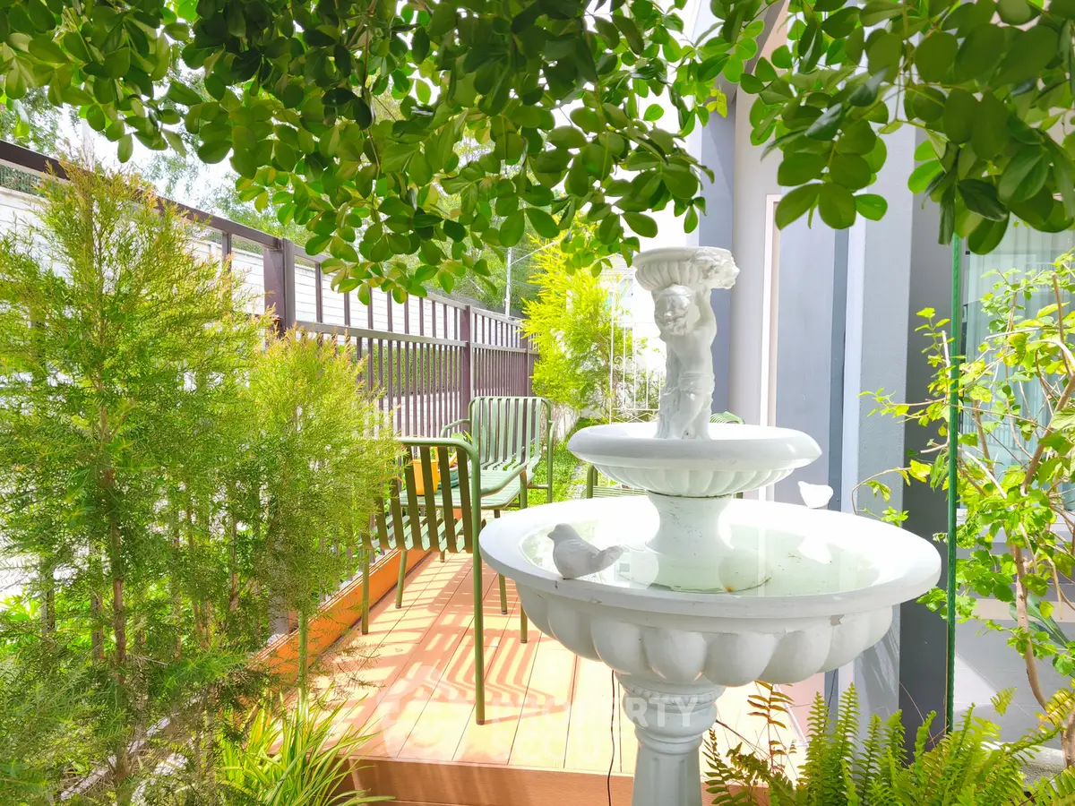 Charming garden patio with elegant fountain and lush greenery, perfect for relaxation and outdoor enjoyment.
