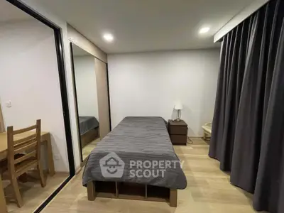 Cozy bedroom with modern decor and ample storage space, perfect for urban living.