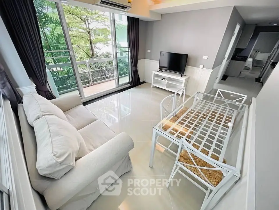 Bright living room with large windows and modern furniture in a stylish apartment.