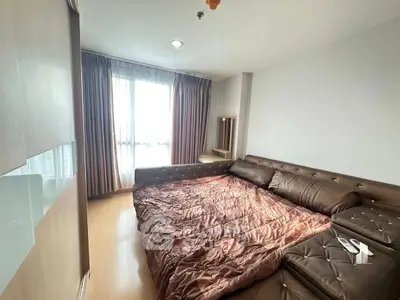 Spacious bedroom with large bed and natural light from window