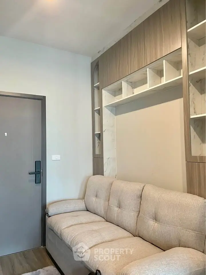 Modern living room with built-in shelving and cozy beige sofa