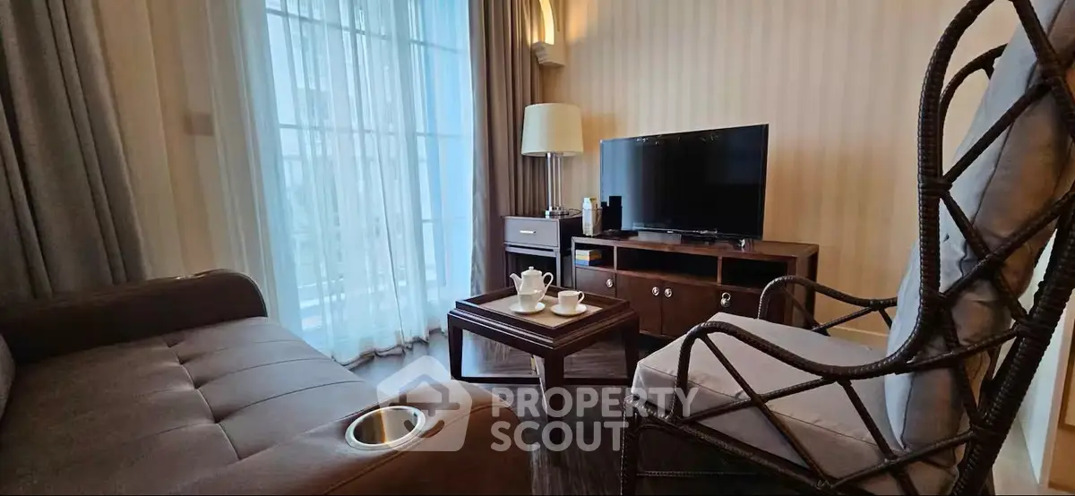 Cozy living room with modern furniture and large window for natural light.