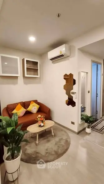 Modern living room with stylish decor and air conditioning, perfect for cozy relaxation.