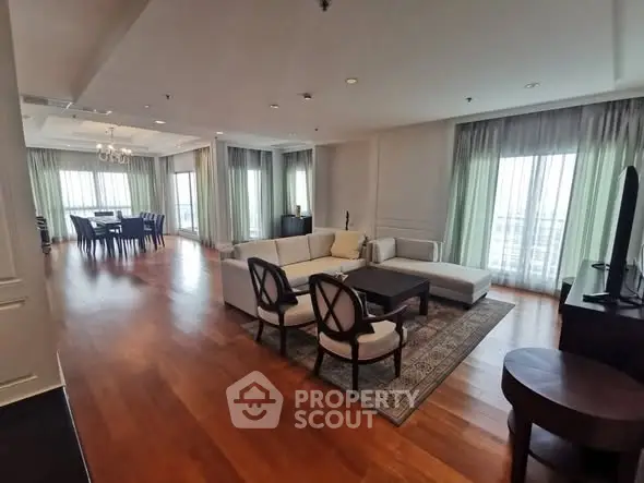 Spacious and elegant living room with hardwood floors and ample natural light.