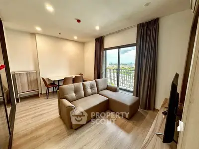 Modern living room with cozy sofa and balcony view