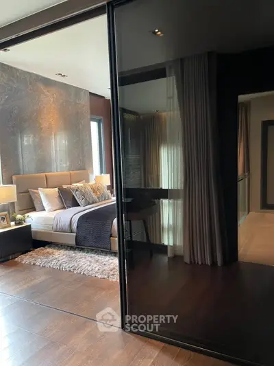 Luxurious bedroom with elegant decor and large windows for natural light.