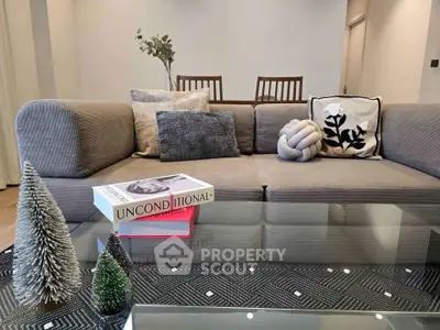 Stylish living room with modern decor and cozy seating area, perfect for relaxation and entertaining.