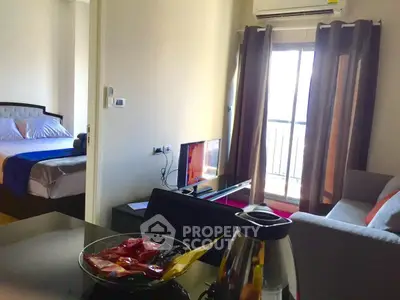 Cozy apartment with modern living room and bedroom, featuring a balcony view.