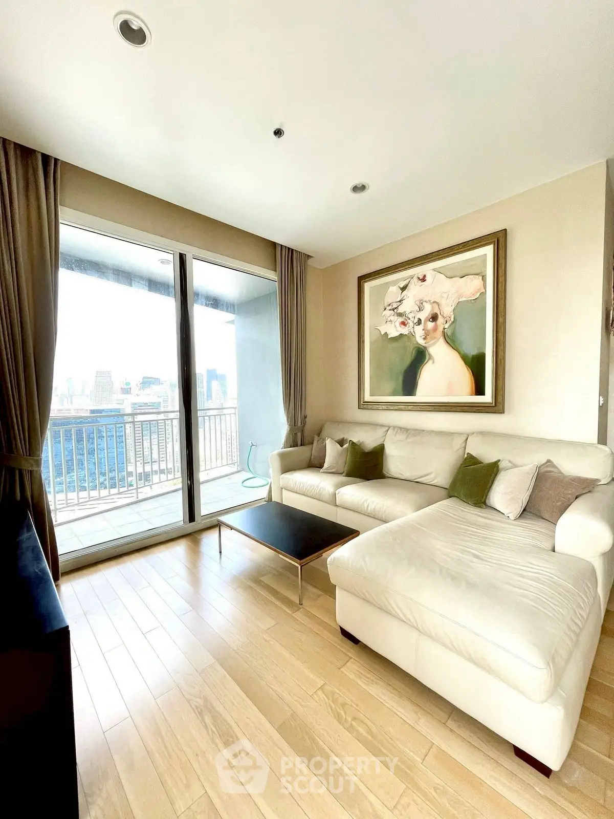 Spacious living room with elegant decor and stunning city view from large balcony.