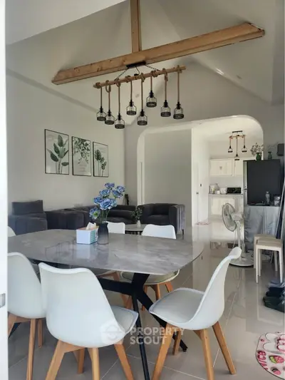 Modern open-plan living and dining area with stylish decor and high ceilings