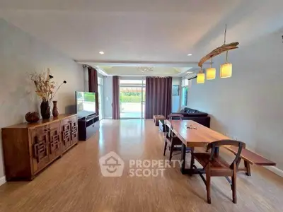Spacious living room with modern decor and large windows for natural light.