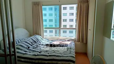 Cozy bedroom with large window and modern decor in urban apartment