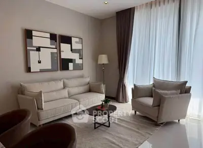 Elegant living room with modern decor and large windows for natural light