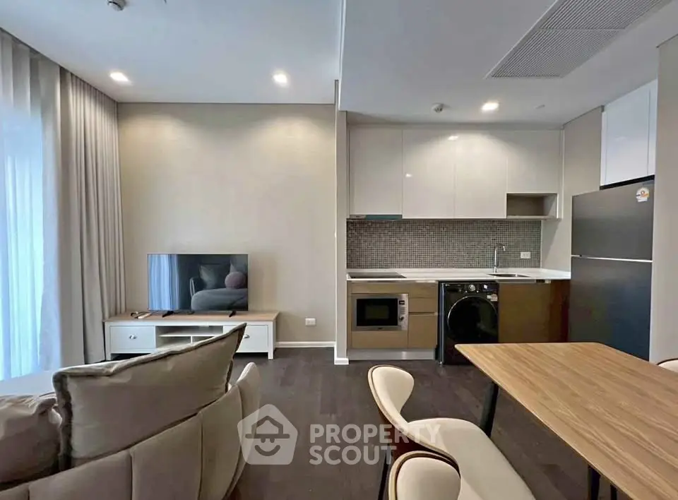 Modern open-plan living room with sleek kitchen and stylish furniture