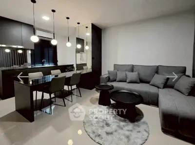 Modern open-plan living room with sleek kitchen and stylish furniture