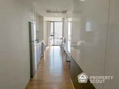 Modern kitchen with sleek design and natural light in a contemporary apartment.