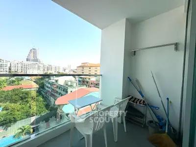 Spacious balcony with city view, perfect for relaxation and outdoor dining.