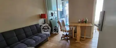 Cozy living room with modern sofa and wooden table, perfect for relaxation.